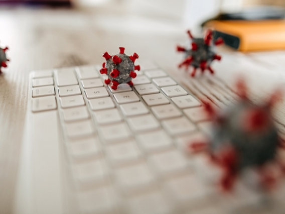 Coronavirus particles on a keyboard stock photo