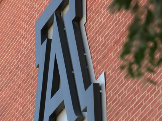 Photo of the UA logo on the side of a building.