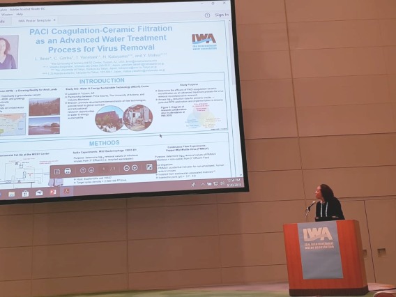 Dr. Luisa Ikner presents poster to attendees of IWA Conference 2018