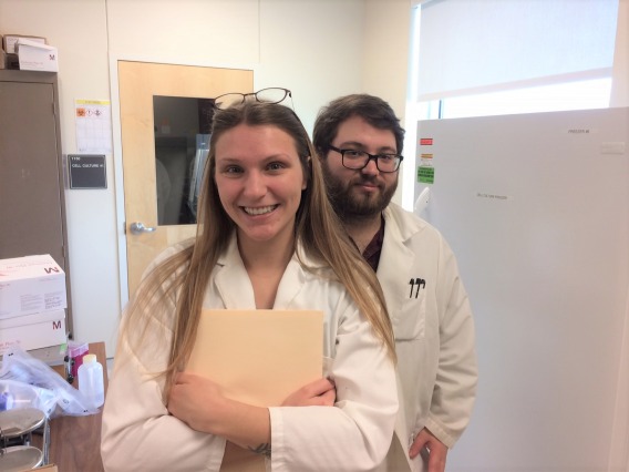Two researchers in lab coats at WEST center