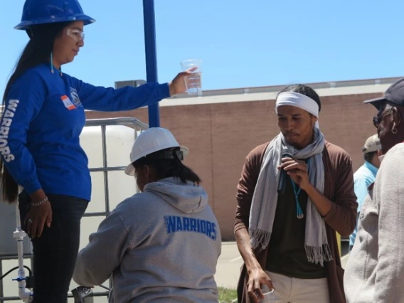 Person giving talk to others outside of WEST center