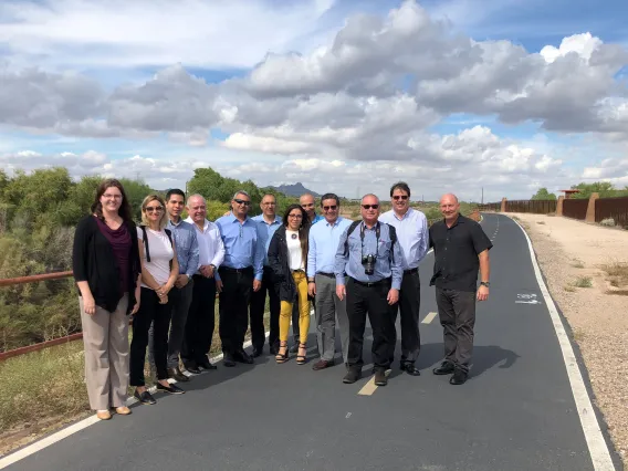 Group photo of people standing on a bike path near WEST Center