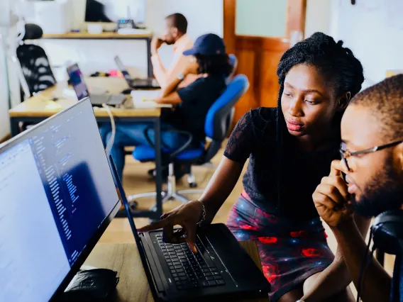 Instructor and trainee at computer