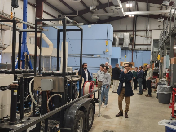 Scientists touring a high bay research facility