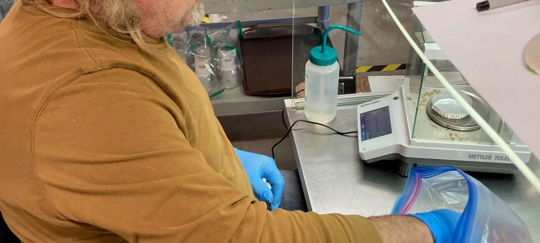 Person weighing soils