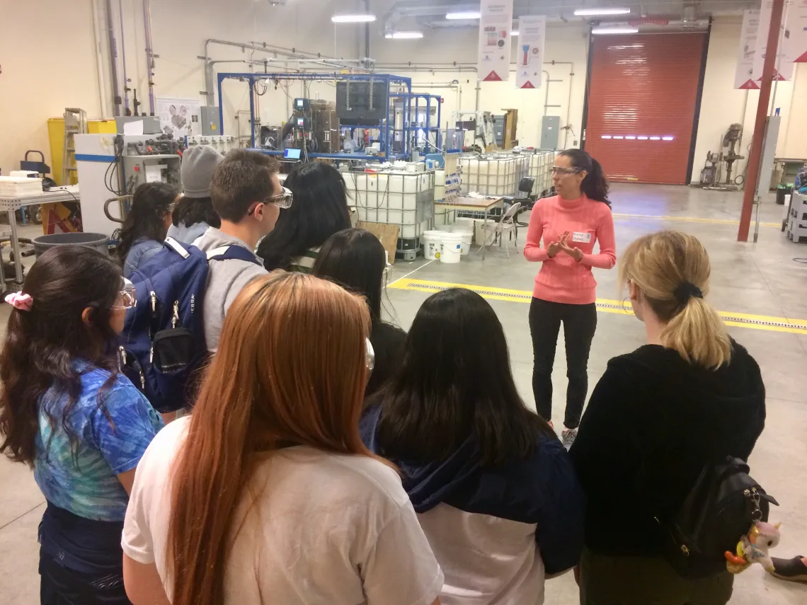 Woman giving a presentation to group of people at WEST Center