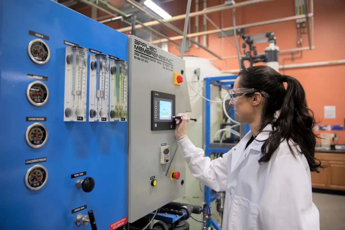 Lab scientist working with a reverse osmosis system at WEST Center