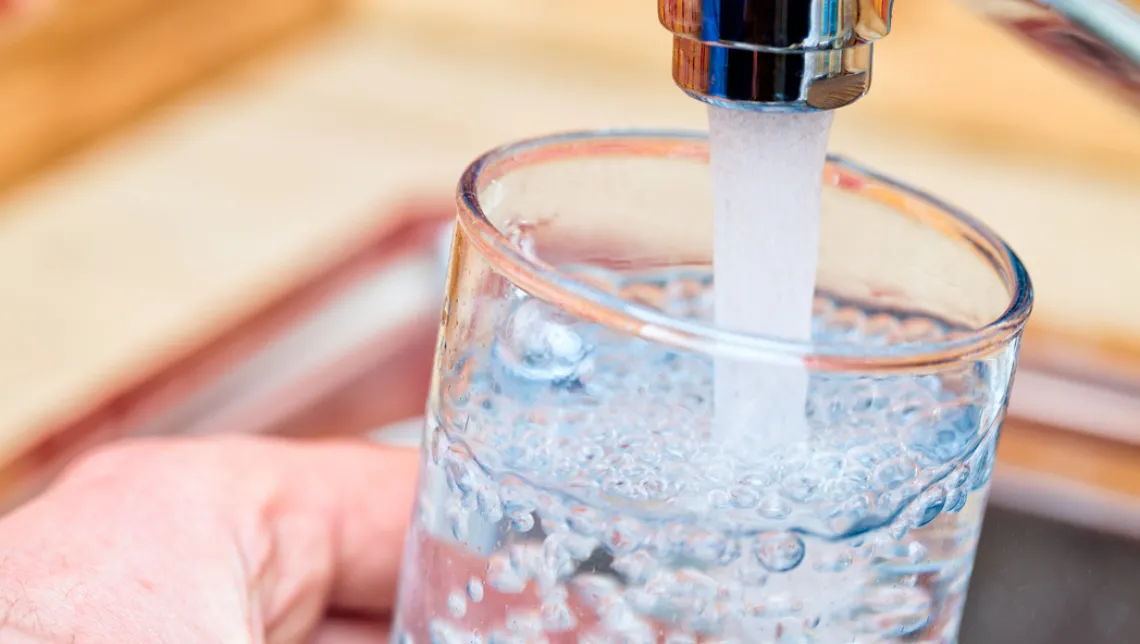 Tap water being dispensed into a glass