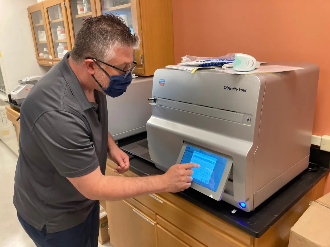 Technician setting up new laboratory equipment.