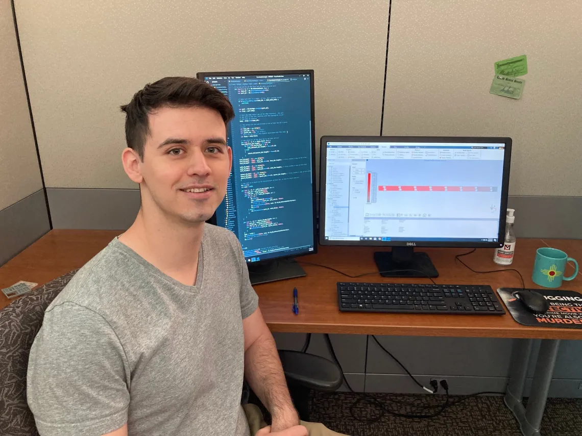 Zachary Binger sitting at a computer desk.