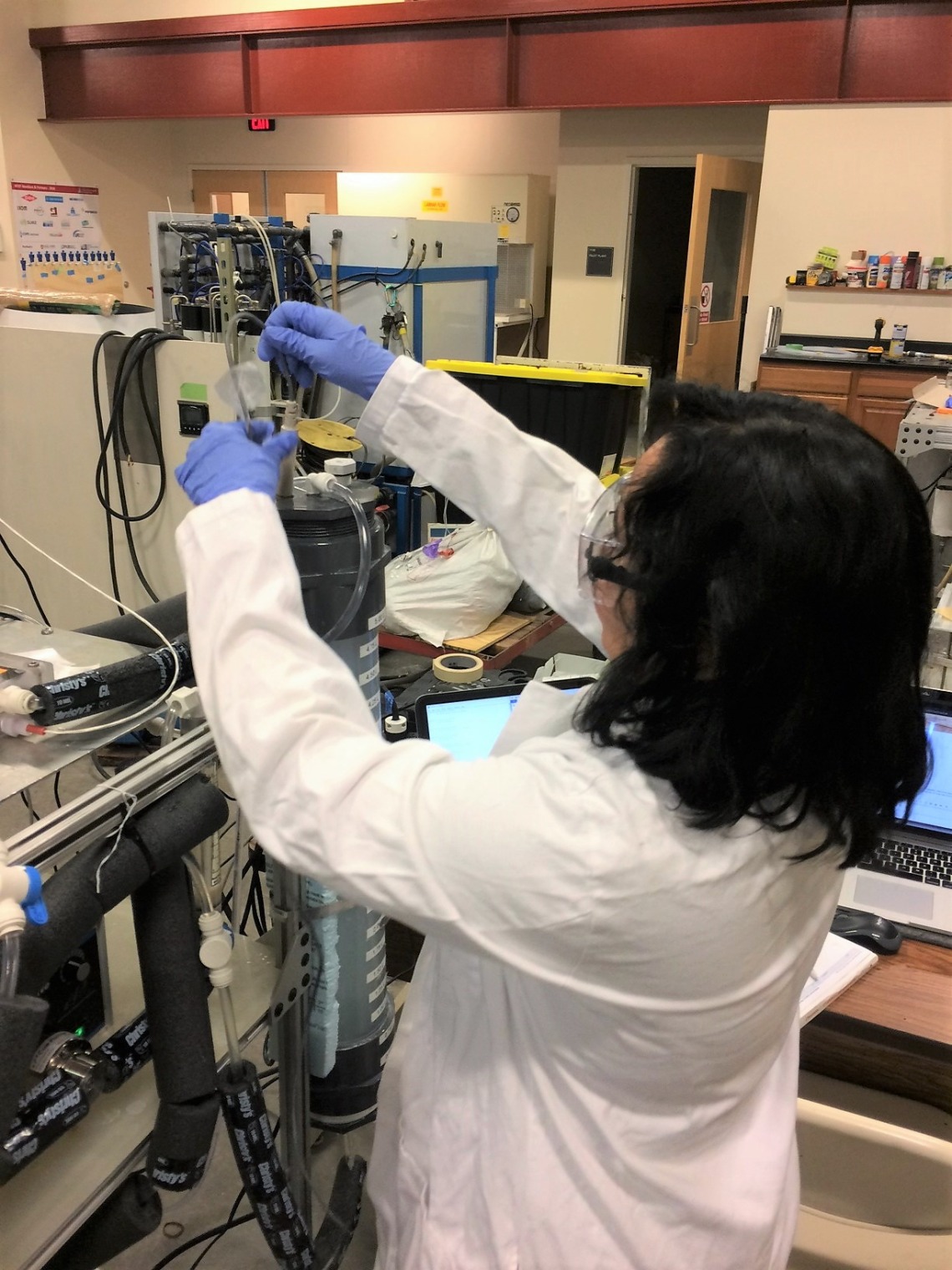 UA student Casandra Flores works on the bench-scale membrane distillation (MD) system