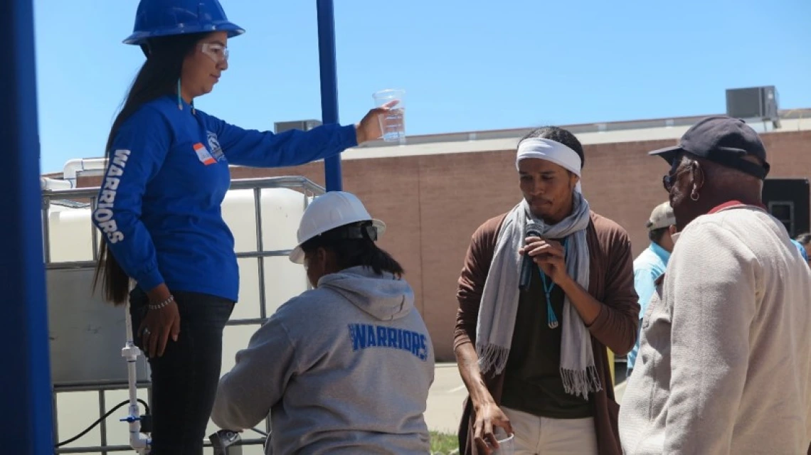 Person giving talk to others outside of WEST center