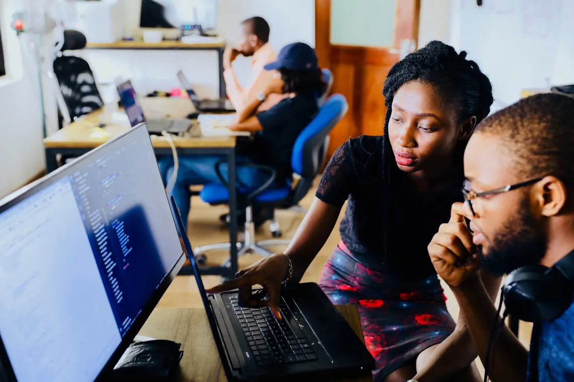 Instructor and trainee at computer