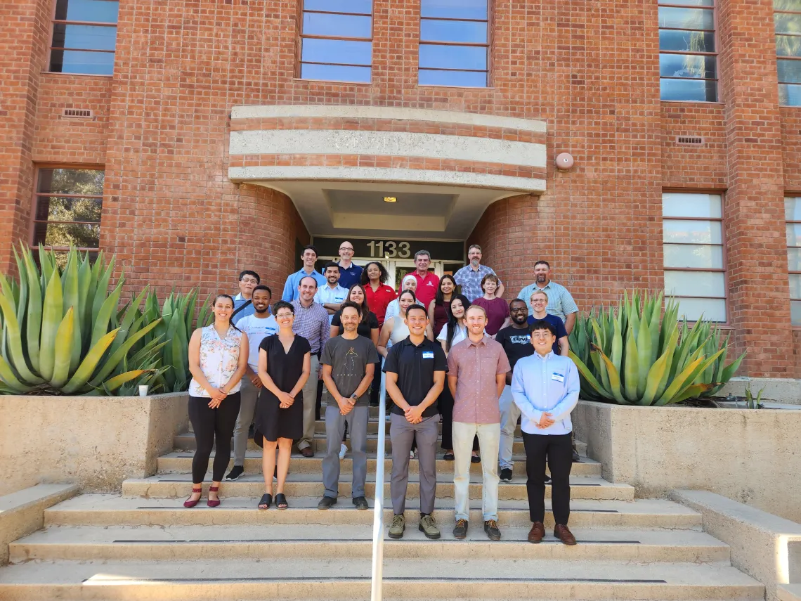 Event participants on the steps of a University of Arizona building