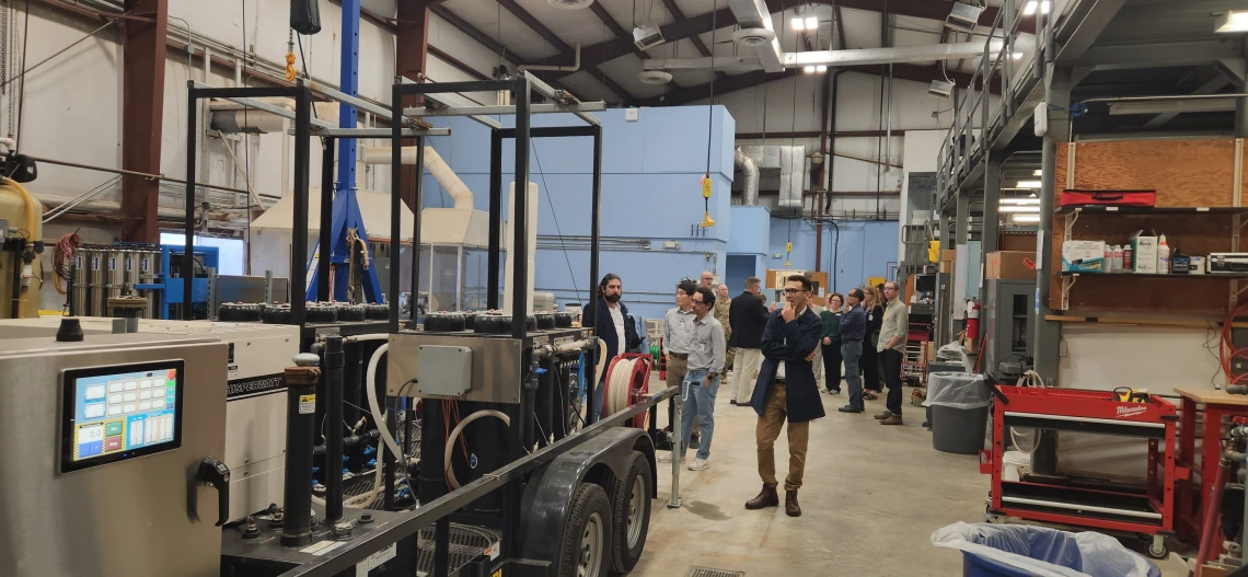 Scientists touring a high bay research facility