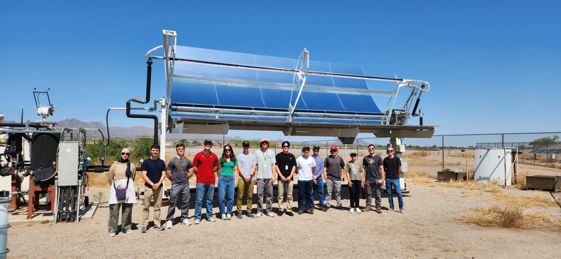 AWP Field School group in front of a large solar panel 